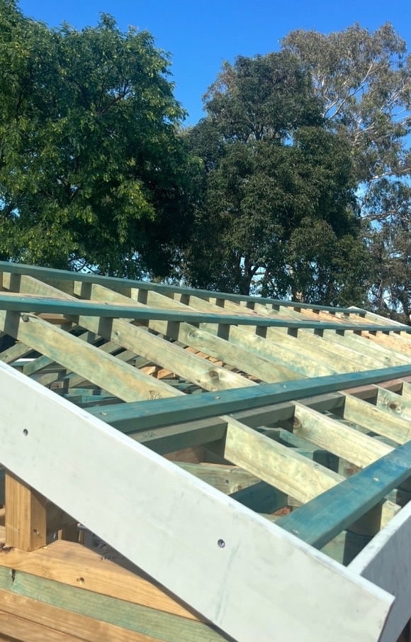 Before: Bare timber roof frame on an extension