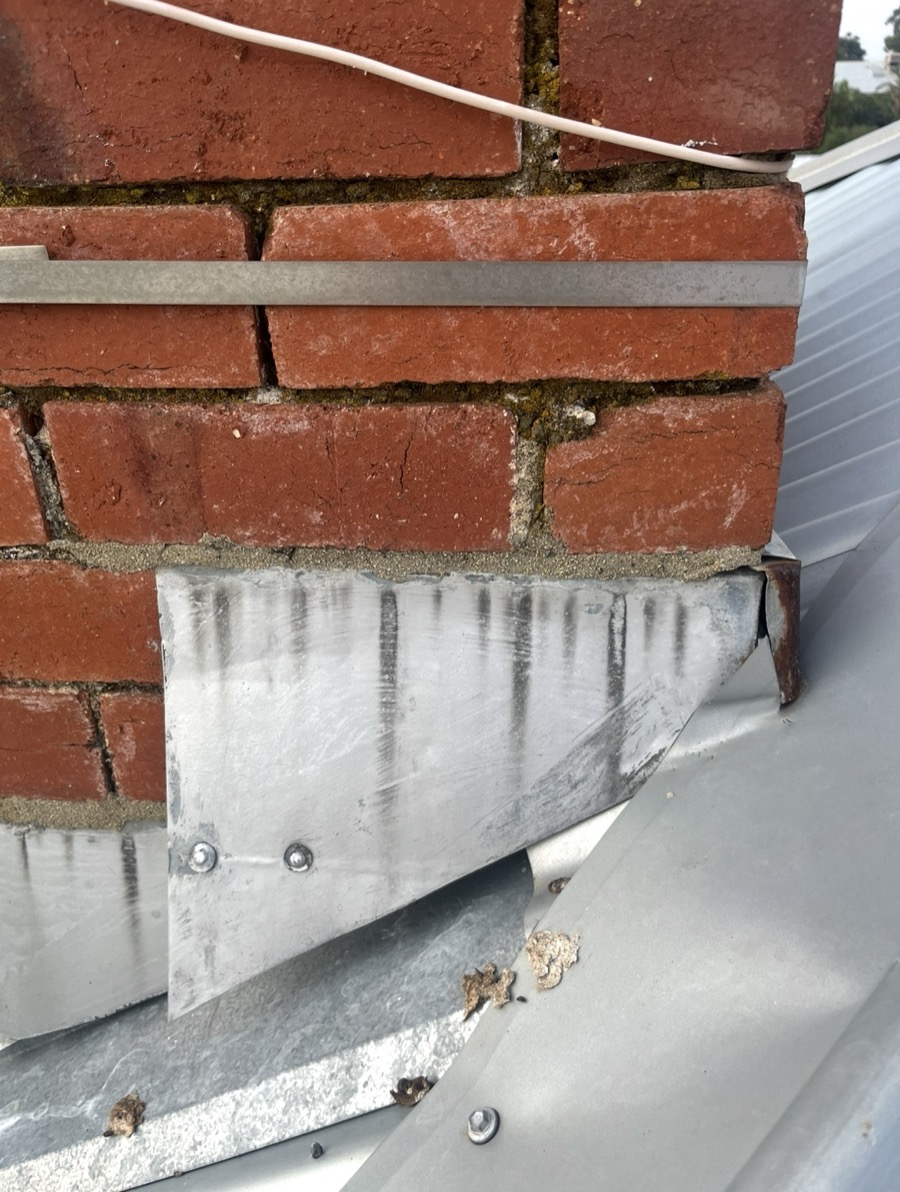 Before: Old chimney flashing lifting away from the brickwork
