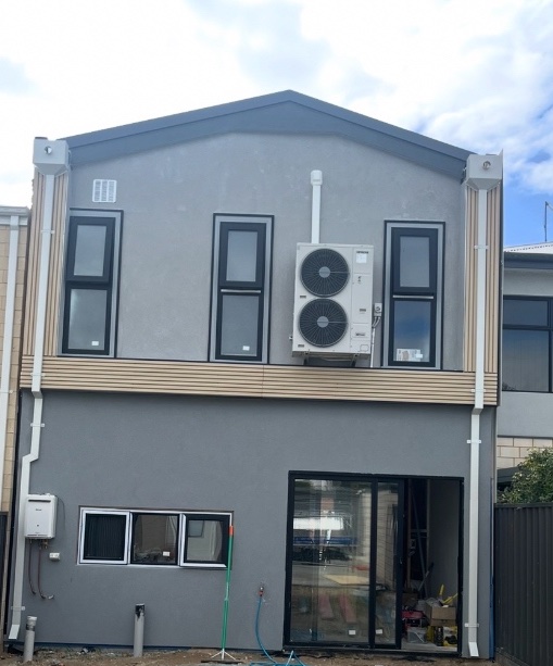 After: The same home with rainheads, downpipes and flashings installed