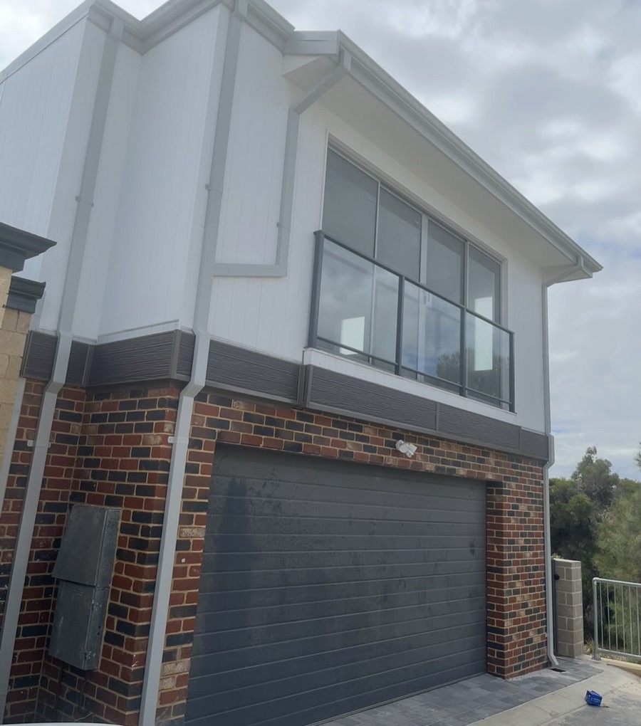 After: The same home with cladding, downpipes and flashings finished