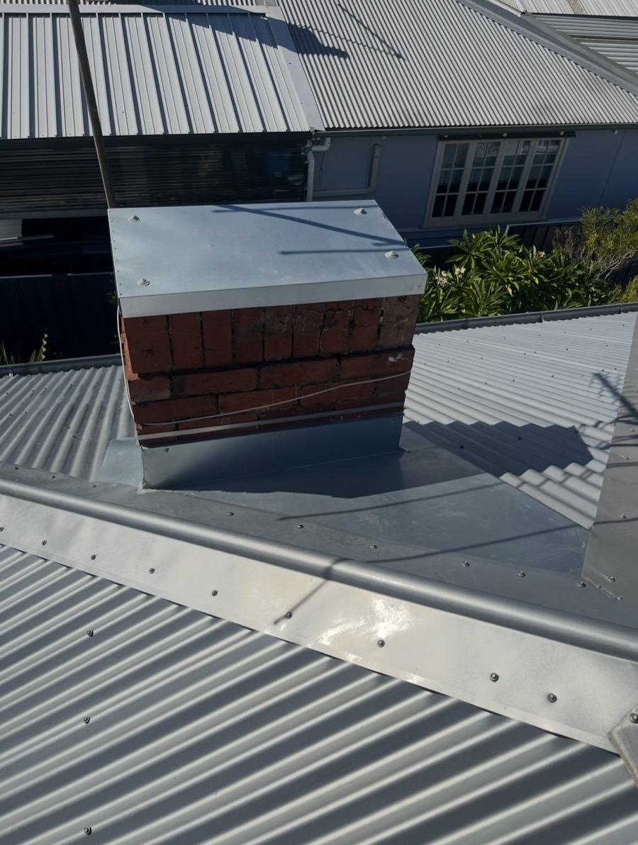 Chimney capped and flashed into a new roof